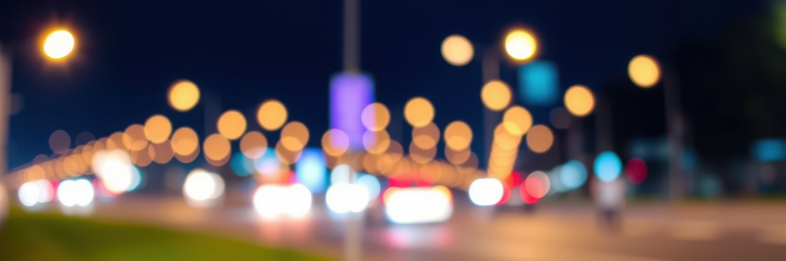 City street lights create a vibrant atmosphere on a bustling night in an urban neighborhood